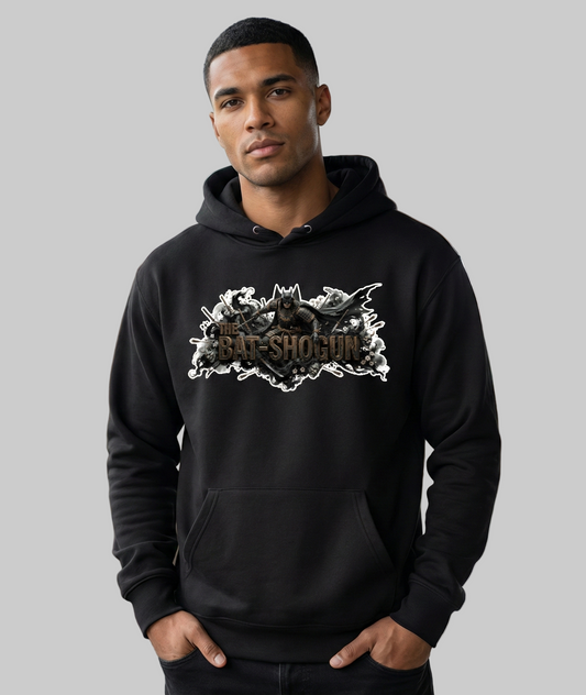 Man wearing a black hoodie with a graphic design in an indoor setting